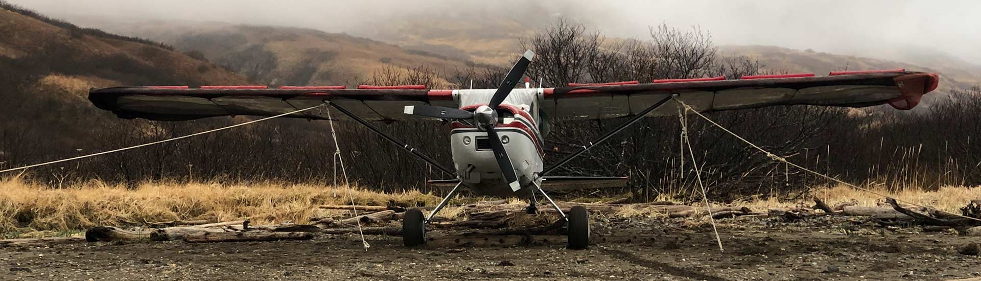 Plane in foggy hills